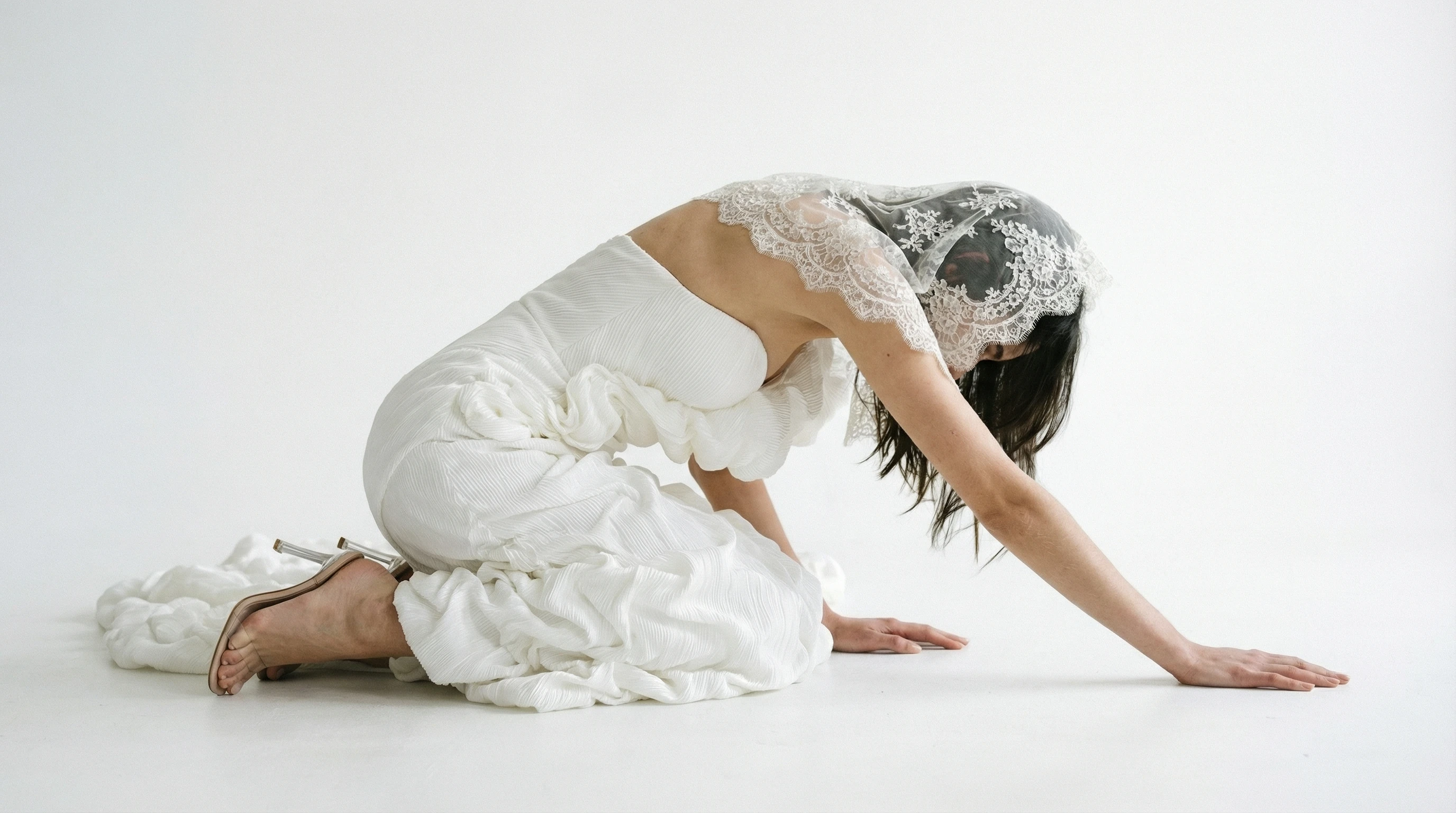 Bride in a pleated gown and lace veil